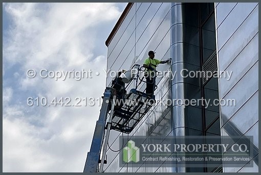 Repairing damaged stainless steel building facade panels.