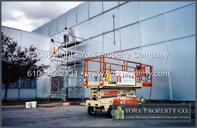 Repairing, preserving and restoring aged, stained, bleached, oxidized and faded anodized aluminum building facade.