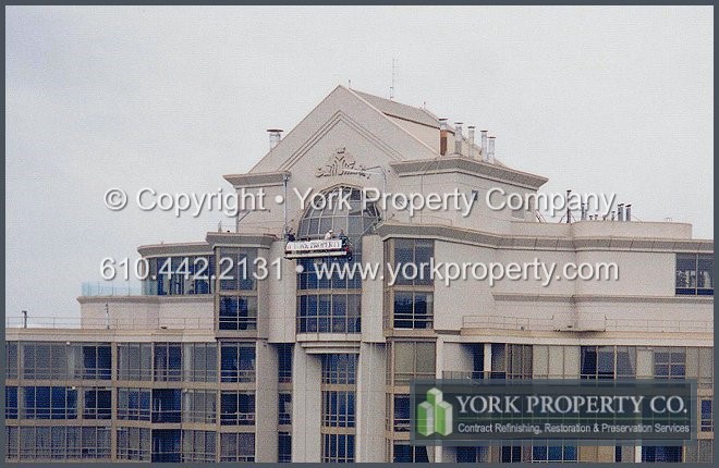 Chalked, faded, pitted and oxidized curtain wall faded paint building restoration.