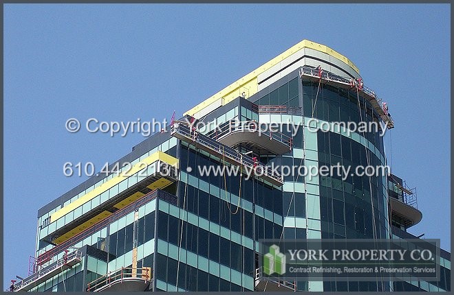 Removing hard water stains from clear anodized aluminum curtain wall window frames, balcony doors and mullions.