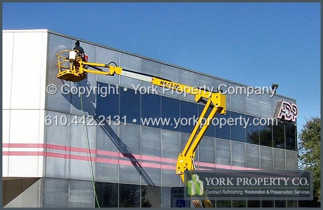 Oxidized, bleached, damaged and stained metal building facade panel repair and metal restoration cleaning.