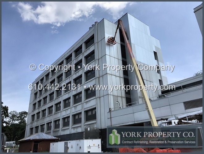 Restoring sun damaged anodized aluminum building facade panels. We clean dirty natural colored anodized aluminum Duranodic facade panels. We restore exterior contaminated anodized aluminum building panel finishes.