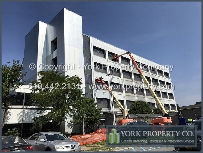 Exterior oxidized anodized aluminum spandrel panel restoration cleaning.