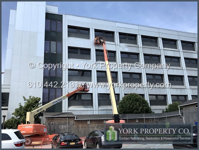 Refinishing stained anodized aluminum cladding.