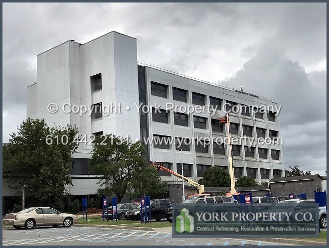 The correct way to clean dirty clear anodized aluminum building facade panels.