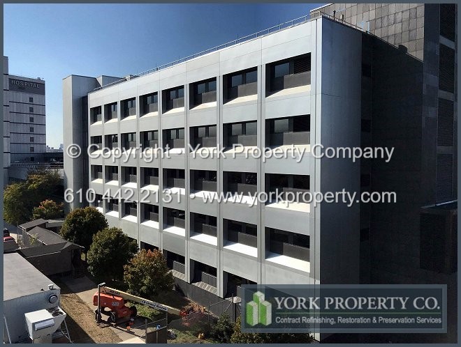 Oxidized clear anodized aluminum building facade panel restoration.