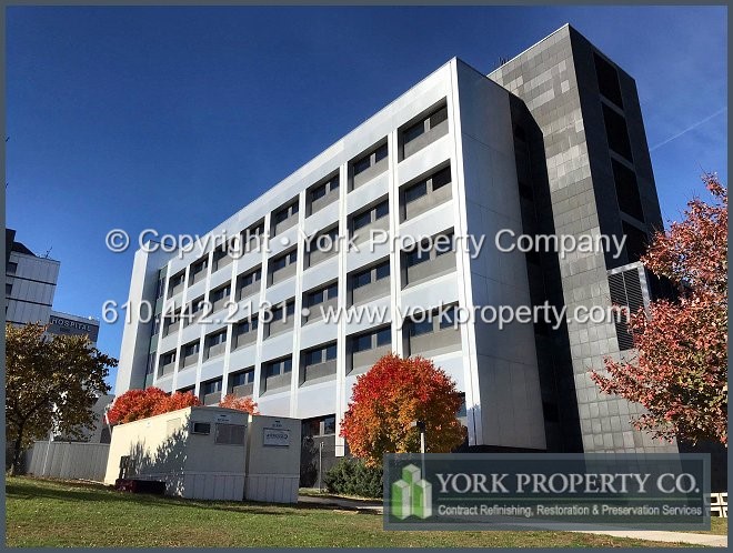 Refinishing sun damaged anodized aluminum facade panels.