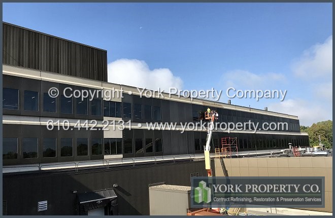 Dirty bronze anodized aluminum building cleaning company.