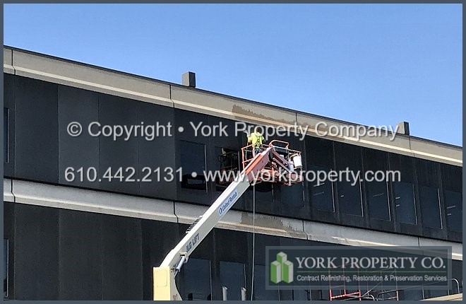 Restoring oxidized anodized aluminum exterior panels.