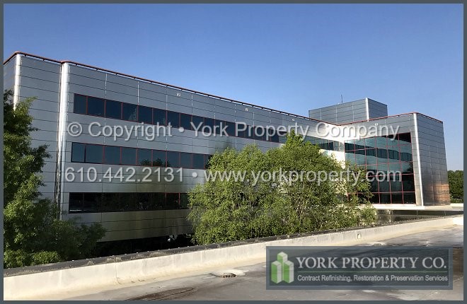 Company that cleans dirty stainless steel building facade panels.